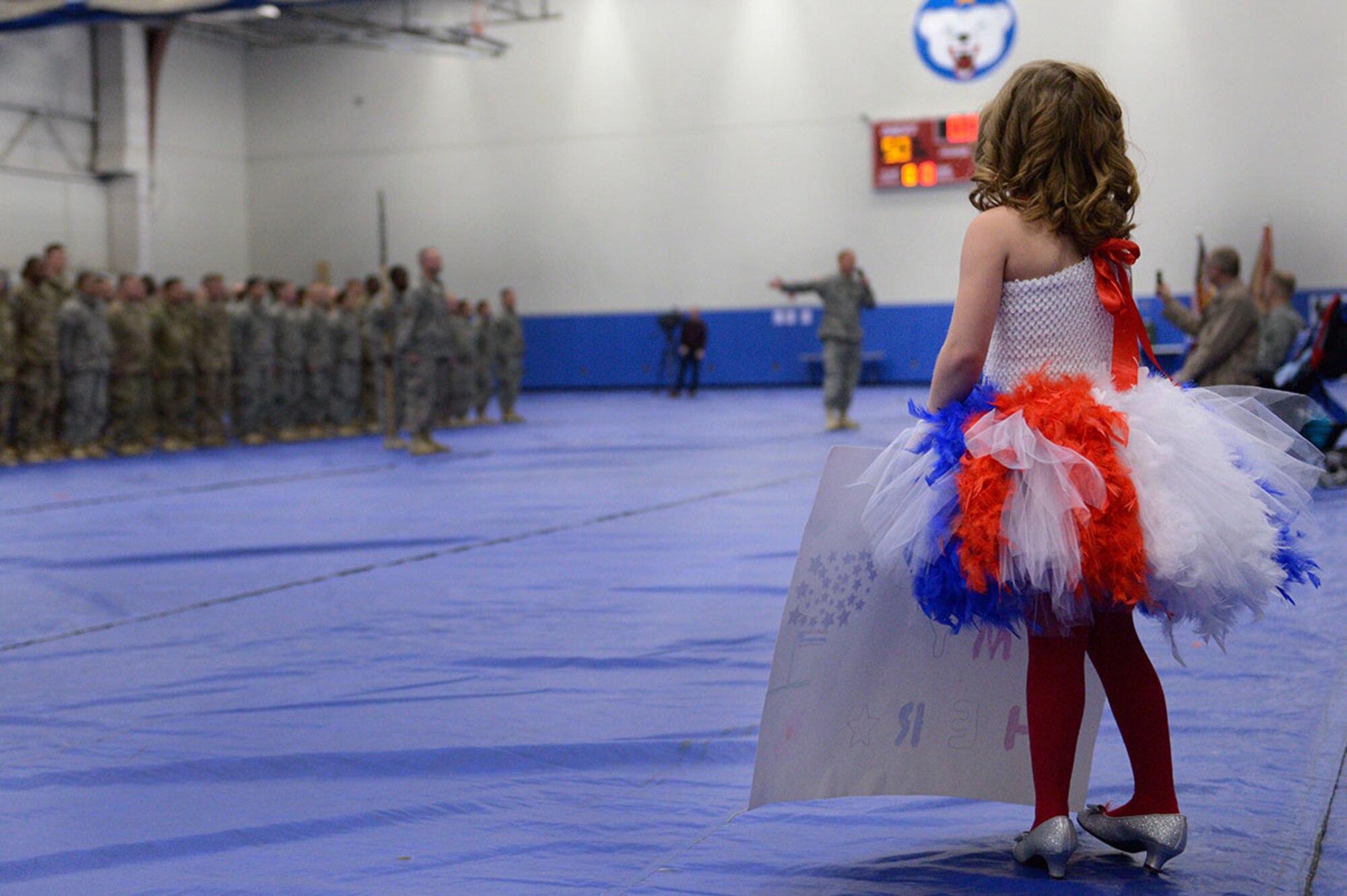 Ashlynn Deer,7, waits for step-father Spc. William Goodwin, assigned to the 98th Maintenance Company, 17th Combat Sustainment Support Battalion, U.S. Army Alaska, during a redeployment ceremony at the Buckner Physical Fitness Center on Joint Base Elmendorf-Richardson, Alaska. April is the Month of the Military Child, which recognizes military children for their commitment, sacrifices and support to the military. (U.S. Air Force photo by Airman Valerie Monroy)