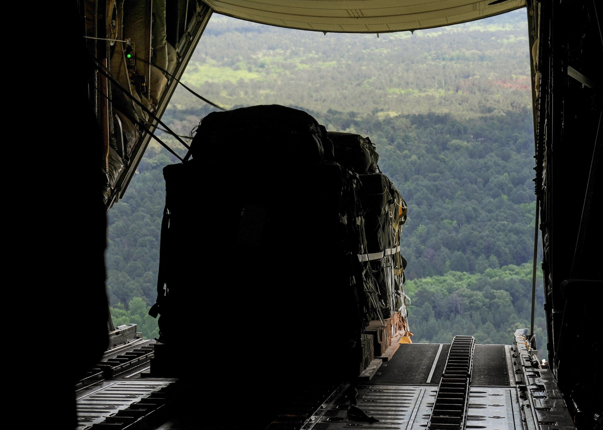 A Container Delivery System is offloaded from the back of a Royal Australian Air Force C-130J April 22, 2016, over Fort Polk, La. U.S. Air Force Airmen from Little Rock Air Force Base, Ark., worked alongside Australian Air Force Airmen during Exercise Green Flag 16-06, a large-scale, joint air mobility exercise. (U.S. Air Force photo/Senior Airman Harry Brexel)  