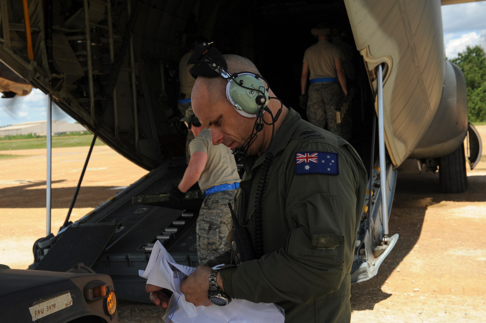 Royal Australian Air Force Warrant Officer Ryan Bowden, No. 37 Squadron C-130J loadmaster, reviews technical orders prior to loading a U.S. Air Force Humvee onto a C-130J April 22, 2016, at Fort Polk, La. The 34th Combat Training Squadron and U.S. Army Soldiers worked closely with coalition forces from Australia, New Zealand and Sweden during a Green Flag air mobility exercise April 14-24, 2016. (U.S. Air Force photo/Senior Airman Harry Brexel)  