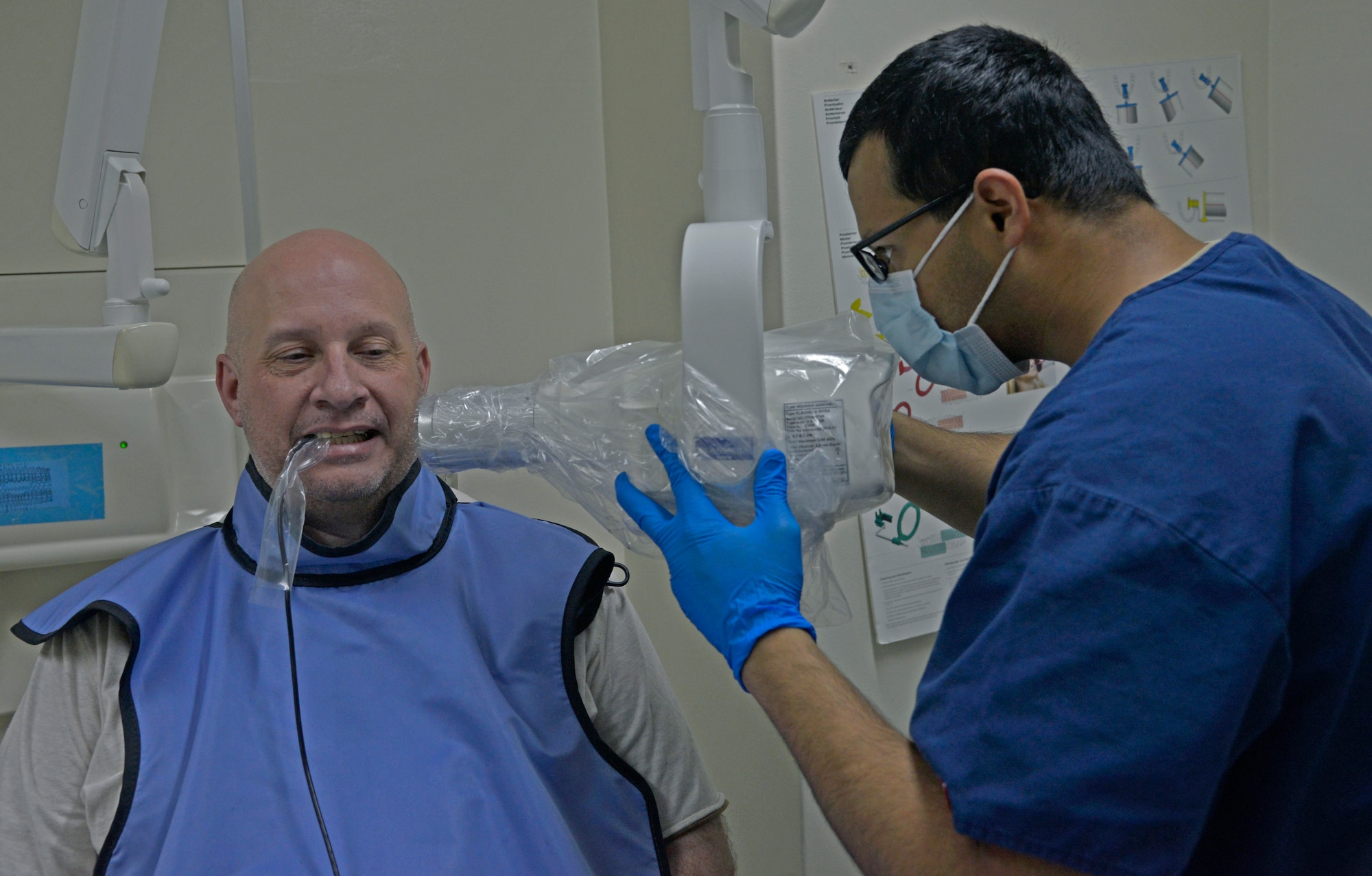 Staff Sgt. Mohammad Farooq, 374th Dental Squadron dental technician, uses an intraoral x-ray machine to take x-rays of the mouth of Michael Kloberdance, Army and Air Force Exchange Service movie theater manager, at Yokota Air Base, Japan, April 19, 2016. The radiology section conducts x-rays of patients’ teeth, helping orthodontics to make a definitive prognosis for dental treatments such as cleanings, fillings, extractions, root canals and facial reconstruction. (U.S. Air Force photo by Senior Airman David Owsianka/Released)