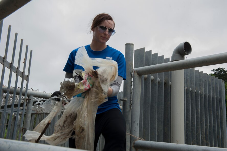 U.S. Air Force Airman 1st Class Stephanie Lopez, 353rd Special Operations Support Squadron cyber systems operations data team member, disposes of trash during an Earth Day clean-up April 22, 2016, at Kadena Air Base, Japan. Kadena was one of more than two million organizations world-wide that participated in Earth Day clean-up activities. Forty-six years after Earth Day’s creation, environmental awareness is still a prominent concern. (U.S. Air Force photo by Airman 1st Class Lynette M. Rolen)