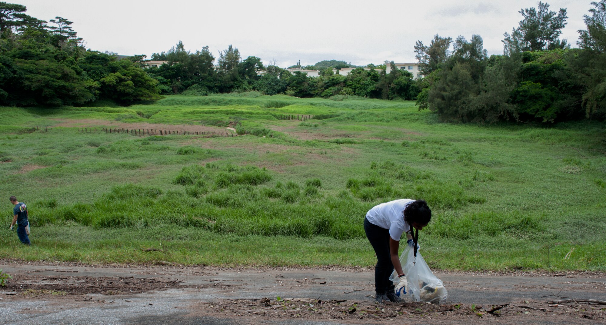 Gira Patel, 718th Civil Engineer Squadron Solid Waste Quality Recycling Program manager, picks up trash during an Earth Day clean-up April 22, 2016, at Kadena Air Base, Japan. Earth Day began in 1970 and has led to many changes throughout the United States, including the creation of the United States Environmental Protection Agency. (U.S. Air Force photo by Airman 1st Class Lynette M. Rolen)