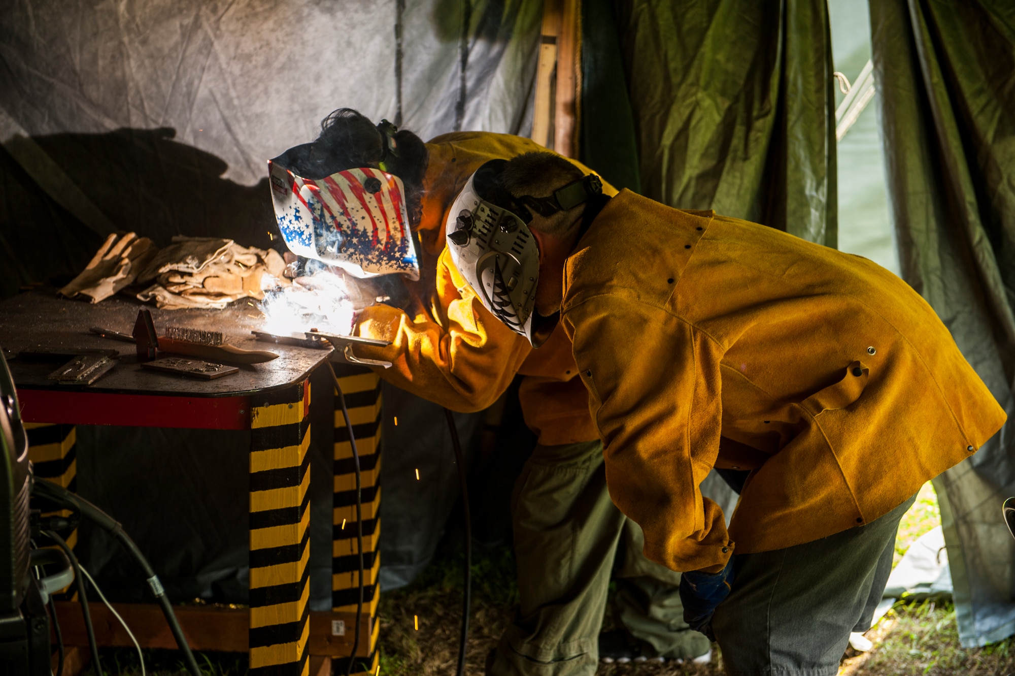 John Black, a member of the Boy Scouts of America, practices welding for his welding merit badge under the instruction of TJ Higgins, the Camp Dragon welding instructor, April 15, 2016, at Torii Station, Japan. The Far East Council, Boy Scouts of America serves more than 2,500 youth members. Camp Dragon was held during the Month of the Military Child, an annual observance held to recognize the year-round contributions, courage and patriotism of the military community’s youngest members. (U.S. Air Force Photo by Airman 1st Class Nick Emerick) 