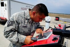 U.S. Air Force Tech. Sgt. Joseph Flores, 612th Air Base Squadron, ensures the live-fire trainer is fully operational during fire extinguishing training during a CENTAM SMOKE (Sharing Mutual Operational Knowledge and Experience) exercise at Soto Cano Air Base, Honduras, April 20, 2016.  During the week-long event, the 34 participants combine classroom lessons with scenarios in the field, using structural, automobile and aircraft live fires, first response medical procedures, patient loading for medical evacuations, familiarization with personal protective gear and using the “Jaws of Life” extraction tool. (U.S. Army photo by Martin Chahin/Released)
