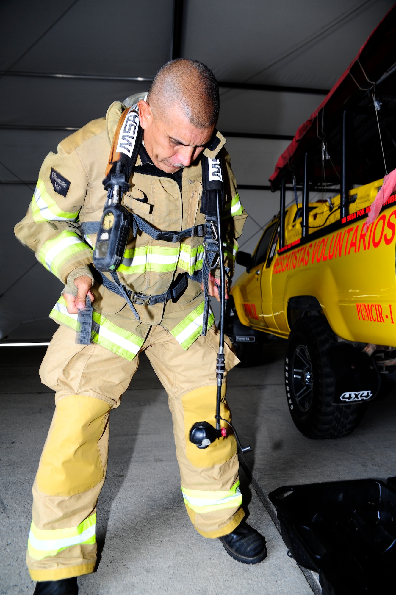 Herberth Gaekel, 612th Air Base Squadron fire inspector, prepares to conduct training for 34 firefighters from the seven countries of Central America during a CENTAM SMOKE (Sharing Mutual Operational Knowledge and Experience) exercise at Soto Cano Air Base, Honduras, April 20, 2016. The purpose of this exercise is to conduct joint training with cross-functional development between all participating countries, to aid and improve humanitarian and civic assistance operations, promoting regional cooperation that will improve collective capabilities and strengthen partnerships. (U.S. Army photo by Martin Chahin/Released)