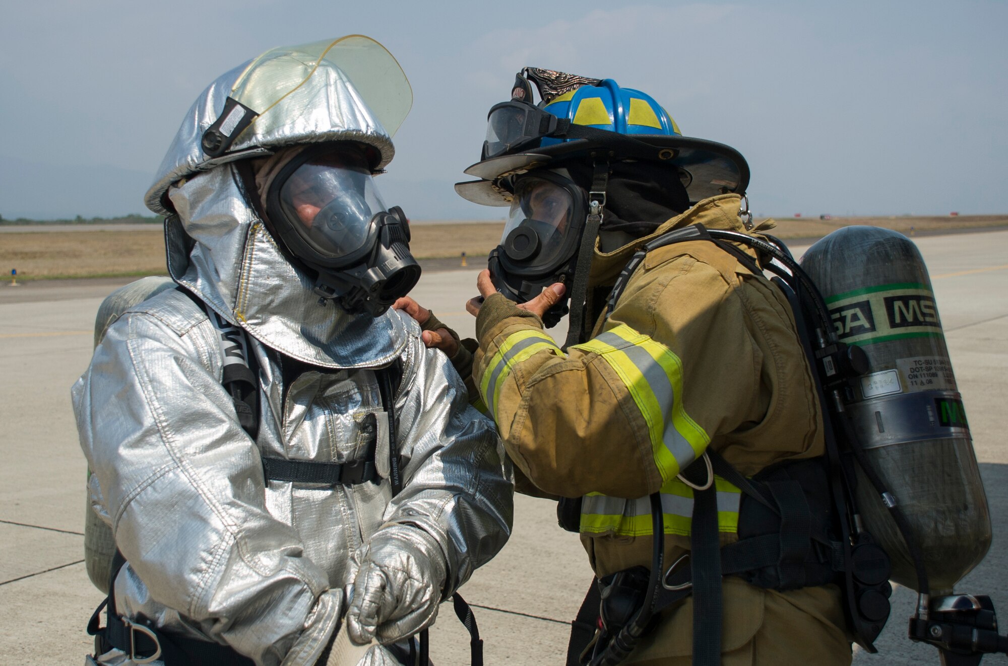 Herberth Gaekel, 612th Air Base Squadron fire inspector, verifies the correct wear of protective gear by one of 34 Central American participants during CENTAM SMOKE (Sharing Mutual Operational Knowledge and Experience), a biannual exercise hosted at Soto Cano Air Base, Honduras, April 19, 2016. During the week-long event, participants combine classroom lessons with scenarios in the field, using structural, automobile and aircraft fires, first response medical procedures, patient loading for medical evacuations, familiarization with personal protective gear, and using the “Jaws of Life” extraction tool. Some firefighters in attendance, and other from previous iterations, helped fight the recent fires near Tela, Honduras. (U.S. Air Force Photo by Capt. David Liapis/Released)
