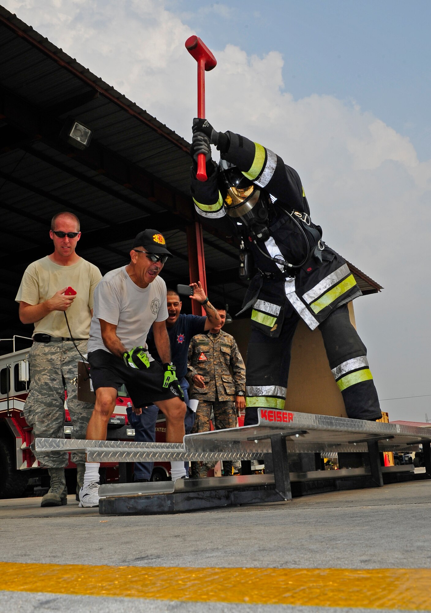 Honduran firefighter  Jorge Betanco strikes a Keiser Sled metal with a sledgehammer during a relay race against 612th Air Base Squadron fire crews during CENTAM SMOKE (Sharing Mutual Operational Knowledge and Experience), a biannual event hosted by Joint Task Force-Bravo at Soto Cano Air Base, Honduras, April 19, 2016. During this iteration, the combined Central American team beat the U.S. team. (U.S. Army photo by Martin Chahin/Released)