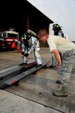 U.S. Air Force Airman 1st Class Robert Verity, 612th Air Base Squadron fire protection specialist, strikes a Keiser Sled with a sledgehammer during a competition with firefighters from Central American nations during a CENTAM SMOKE (Sharing Mutual Operational Knowledge and Experience) exercise at Soto Cano Air Base, Honduras, April 19, 2016. During the week-long event, participants combine classroom lessons with scenarios in the field using live structural, automobile and aircraft fires, first response medical procedures, patient loading for medical evacuations, familiarization with personal protective gear, and using the “Jaws of Life” extraction tool. (U.S. Army photo by Martin Chahin/Released)