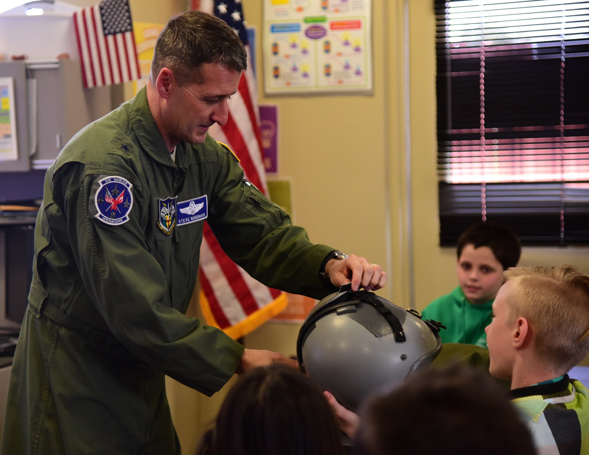 PETERSON AIR FORCE BASE, Colo. - Brig. Gen. Steven Nordhaus, NORAD deputy director of operations, explains the various functions of a fighter pilots helmet to students of Starbase Academy at Peterson Air Force Base, Apr. 8, 2016. The students of Starbase, fifth graders from local elementary schools, participate in a five-day program learning advanced science, technology, engineering and mathematics. (U.S. Air Force photo by Staff Sgt. Amber Grimm)