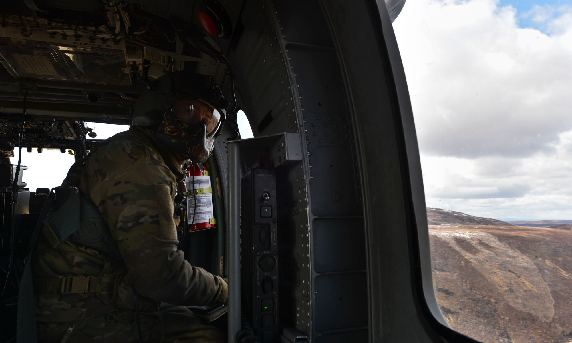 Staff Sgt. Joseph Bland, 56th Rescue Squadron special mission aviator instructor, surveys the terrain during a training exercise at Joint Warrior 2016 at Royal Air Force Lossiemouth, Scotland, April 15. The training for the 56th RQS not only provides insight from its coalition counter parts, but prepares the squadron for any tasking in the future. (U.S. Air Force photo/Senior Airman Nigel Sandridge)