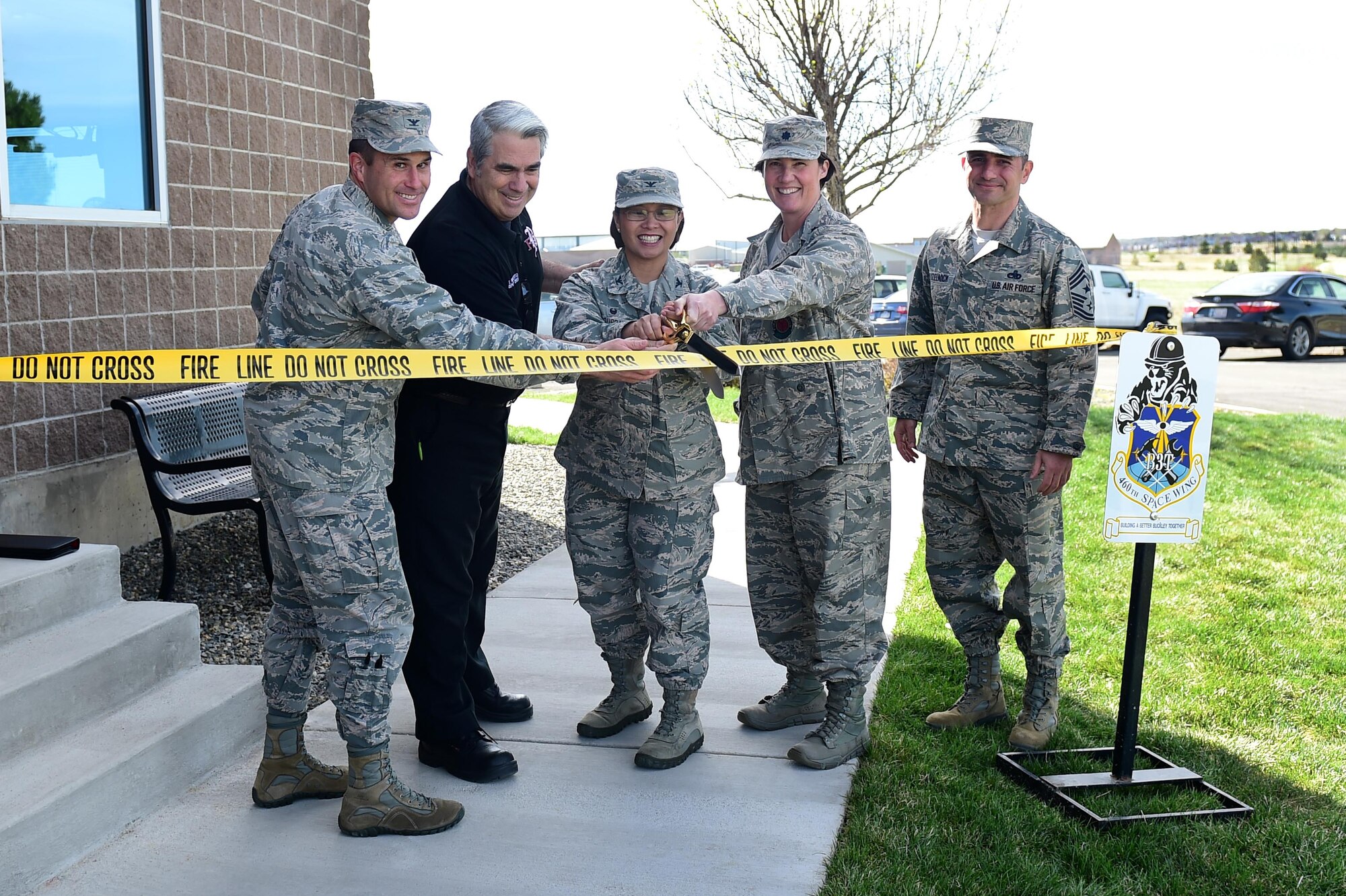 Team Buckley leadership join Tim Ruperto, Buckley Fire Department deputy chief, for a ribbon cutting ceremony April 25, 2016, at the fire department on Buckley Air Force Base, Colo. The ceremony symbolized the completion of new fire station bunkrooms, Building a Better Buckley Together project, which will facilitate firefighters being housed at one location. (U.S. Air Force photo by Airman 1st Class Gabrielle Spradling/Released)