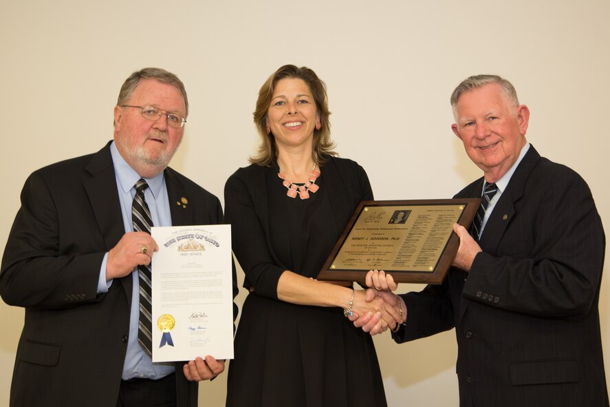 Mr. Warren Brown (left) and Mr. Lyle Lockwood present AFRL Biological Materials Researcher Dr. Wendy Goodson with the Outstanding Engineers and Scientists Award at the 57th Annual Affiliate Societies Council Banquet and Awards Ceremony on April 21, 2016.  (Photo courtesy of Affiliate Societies Council/Jim Solomon)