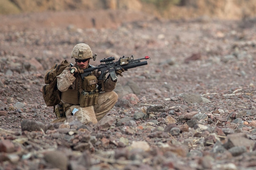 U.S. Marine Corporal Joshua Baker with the 13th Marine Expeditionary Unit sends and receives information over his radio during Tactical Recovery of Aircraft and Personnel training at Training Area Bravo 1, Djibouti, Africa, April 19, 2016. The 13th MEU is deployed in support of maritime security operations and theater cooperation efforts in the U.S. 5th fleet area of operations. (U.S. Marine Corps photo by Sgt. Hector de Jesus/RELEASED)