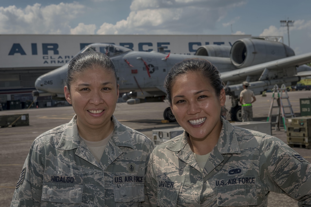 U.S. Air Force Tech. Sgt. Kathlyn Hidalgo (left), an independent duty medical technician with the 25th Fighter Squadron, and Senior Airman Nikkie Javier (right), a precision guided munitions crew chief with the 51st Munitions Squadron, both deployed from Osan Air Base, Republic of Korea, pose for a photo in front of an A-10C Thunderbolt II at Clark Air Base, Philippines, April 22, 2016. Hidalgo and Javier are two of three Filipino-American Airmen serving U.S. Pacific Command’s newly stood up Air Contingent in the Philippines. Hidalgo is from Guiguinto, Bulacan, Philippines, and Javier is a Norwalk, California, native. (U.S. Air Force photo by Staff Sgt. Benjamin W. Stratton)