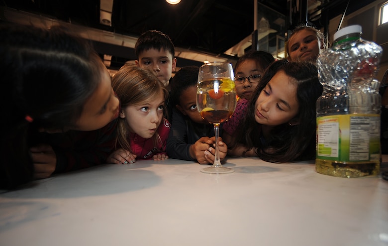 Humphreys Central Elementary School students Cadence Meno (left) Kyleigh Odem (center) and Danielle Graham (right) watch things float during a demonstration on displacement at the school’s Science, Technology, Engineering and Math day on April 19.