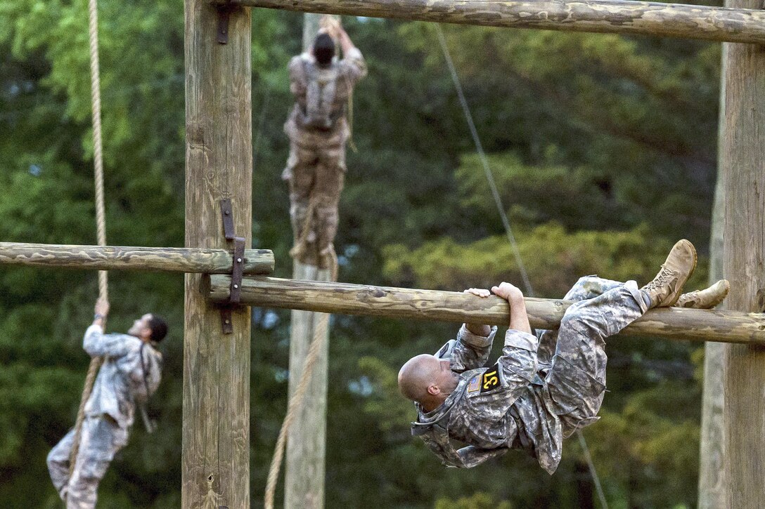 Army Capt. Jason Parsons and other soldiers maneuver through obstacles while participating in the 2016 Best Ranger Competition at Fort Benning, Ga., April 15, 2016. Army courtesy photo by Cpl. Alana Morin, Canadian Forces Joint Imagery Centre