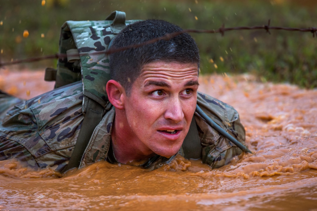 An Army Ranger crawls through a water obstacle during the Best Ranger Competition at Fort Benning, Ga., April 15, 2016. Army photo by Pfc. Christopher Brecht