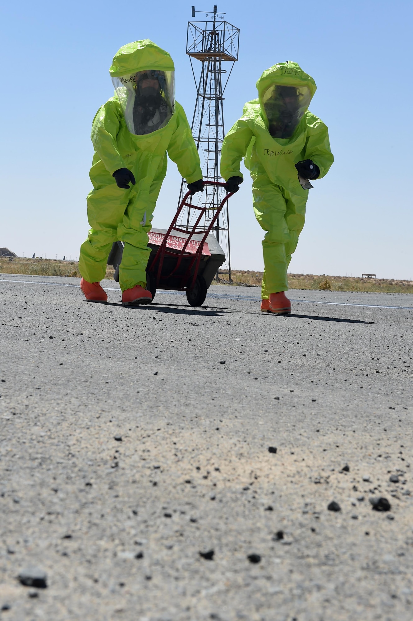 A firefighter from the 386th Expeditionary Civil Engineer Squadron and a firefighter from the 332nd ECES respond to a simulated chlorine gas leak during a Hazardous Materials Technician Certification course exercise at an undisclosed location in Southwest Asia, April 15, 2016. Fire department, emergency management and medical teams from the two wings participated in the exercise which tested their knowledge and skills in safely recognizing and mitigating a hazardous material accident. (U.S. Air Force photo by Staff Sgt. Jerilyn Quintanilla)