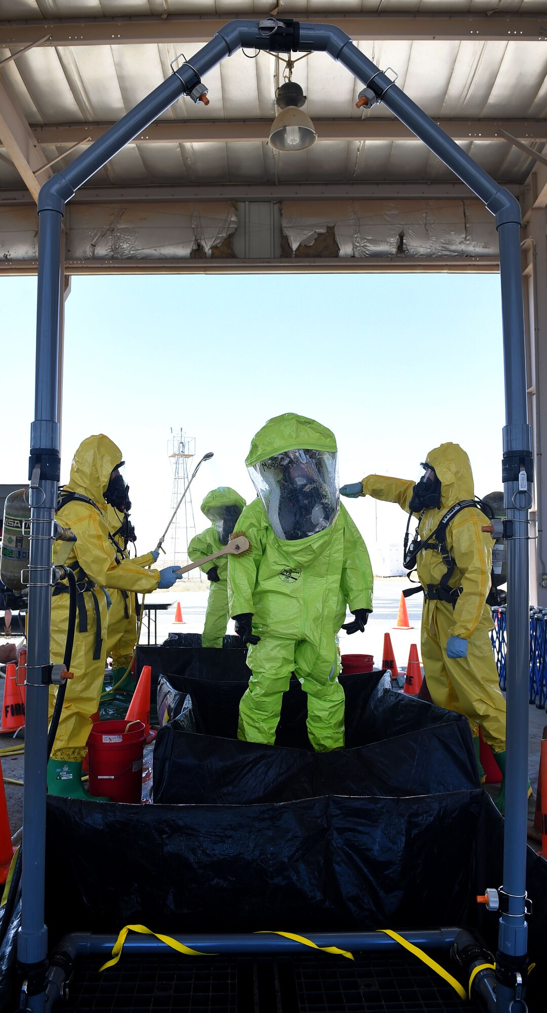 An Airman from the 386th Expeditionary Civil Engineer Squadron goes through the decontamination process during a Hazardous Materials Technician Certification course exercise at an undisclosed location in Southwest Asia, April 15, 2016. The exercise simulated a chlorine gas leak to which the fire department, emergency management and medical teams from the 386th and 332nd ECES teams responded. (U.S. Air Force photo by Staff Sgt. Jerilyn Quintanilla)