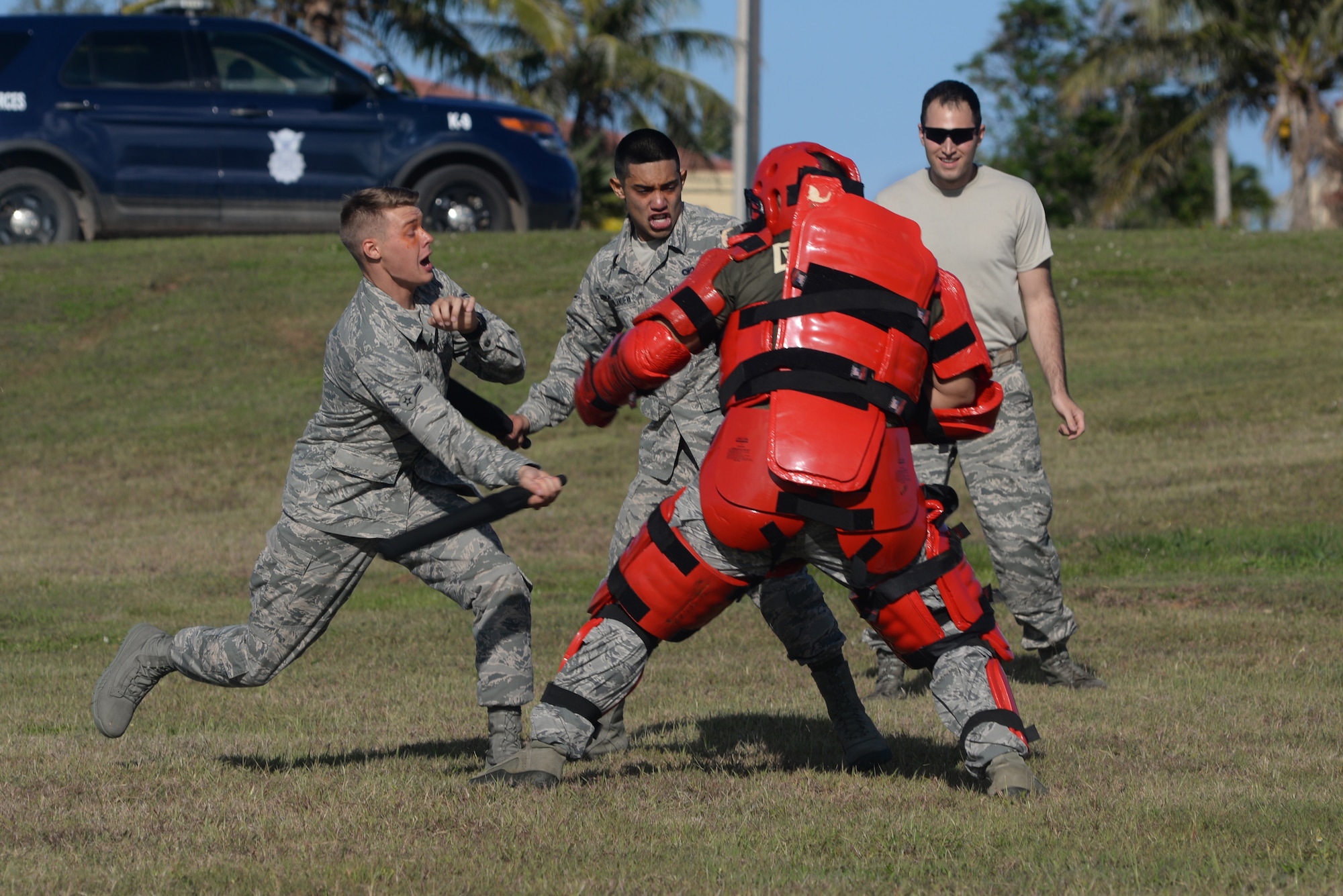 Airman Trevor Mollman and Airman 1st Class Justin Villanueva, 36th Security Forces Squadron unit orientation training members, fight an adversary role player after being sprayed with oleoresin capsicum March 25, 2016, at Andersen Air Force Base, Guam. After completing an obstacle course individually, the Airmen team up to subdue an adversary as their final obstacle. (U.S. Air Force photo by Airman 1st Class Jacob Skovo)