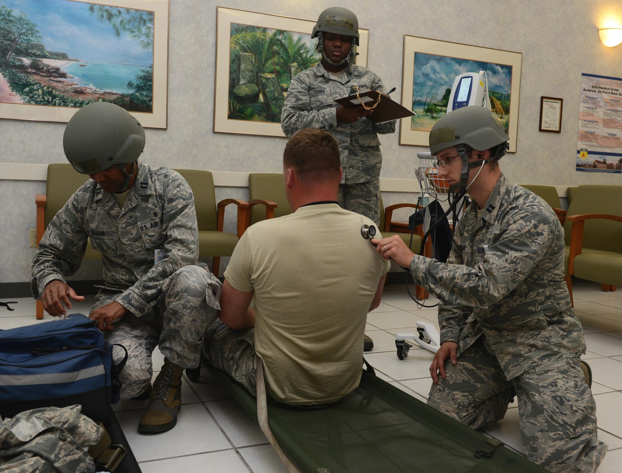 Airmen with the 36th Medical Group simulate responding to a casualty during Operational Readiness Exercise Sling Stone 16-03 April 19, 2016, at Andersen Air Force Base, Guam. The Airmen assessed the casualty’s airway and checked his pulse. (U.S. Air Force photo by Airman 1st Class Arielle Vasquez/Released) 