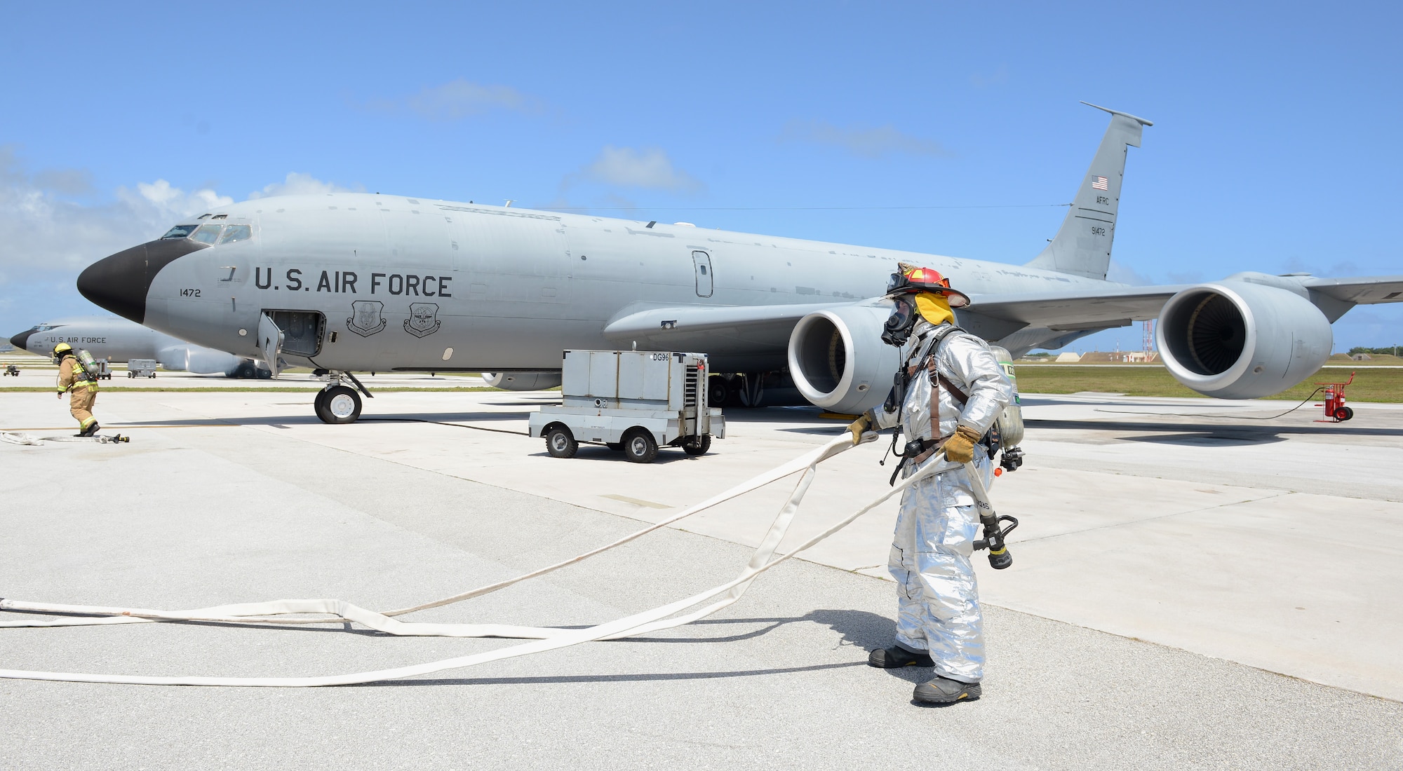 36th Civil Engineer Squadron firefighters pull hoses to combat a simulated fire on the flightline during an operational readiness exercise April 20, 2016, at Andersen Air Force Base, Guam. The scenario was part of a four-day ORE which tested the wing’s preparedness for wartime scenarios. (U.S. Air Force photo by Airman 1st Class Arielle Vasquez/Released)