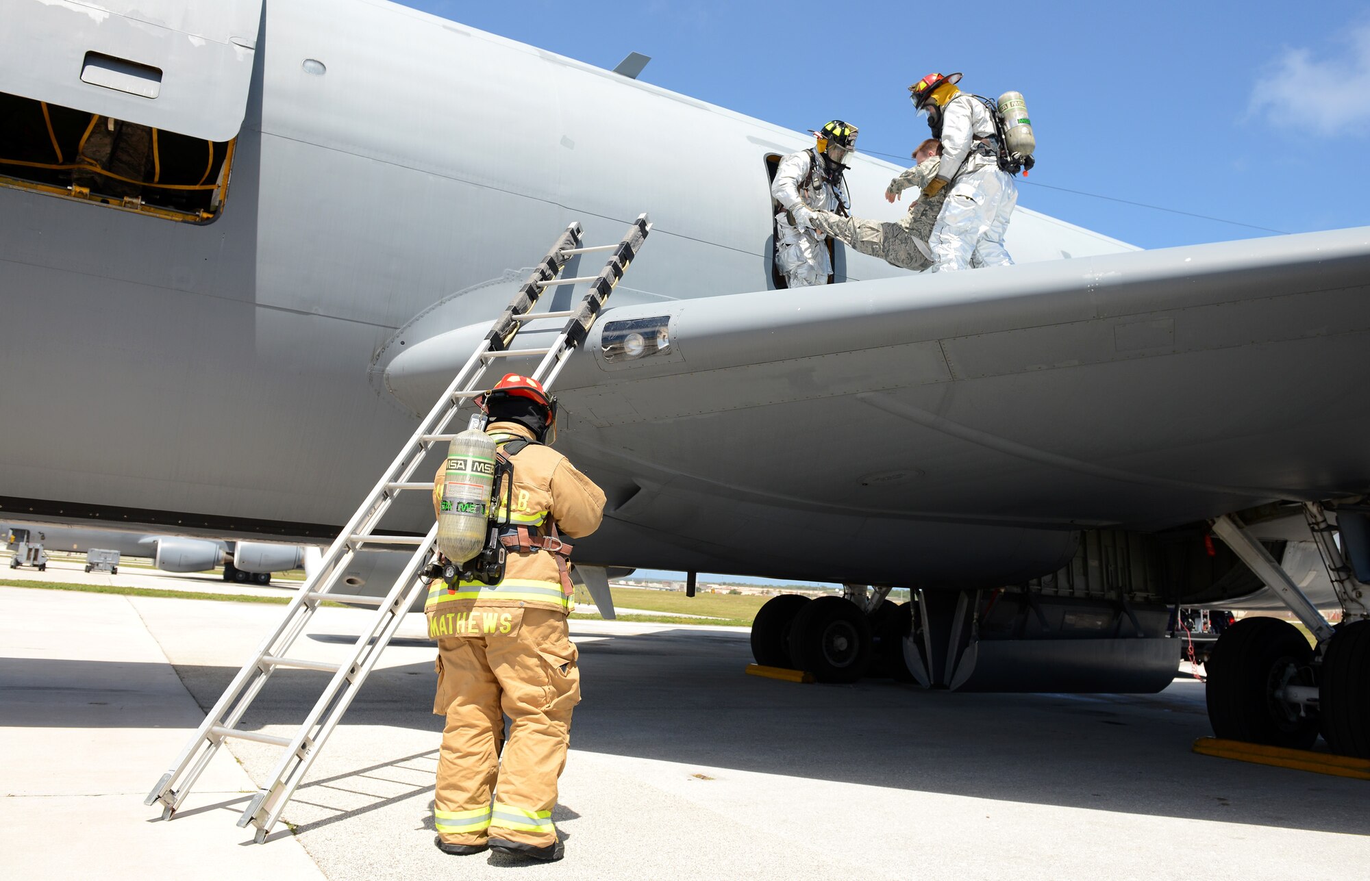 Firefighters with the 36th Civil Engineer Squadron practice egress training on a KC-135 Stratotanker on the flightline during an operational readiness exercise April 20, 2016, at Andersen Air Force Base, Guam. Egress training involves learning how to enter an aircraft to rescue any personnel on board should they become incapacitated during an emergency situation. (U.S. Air Force photo by Airman 1st Class Arielle Vasquez/Released)