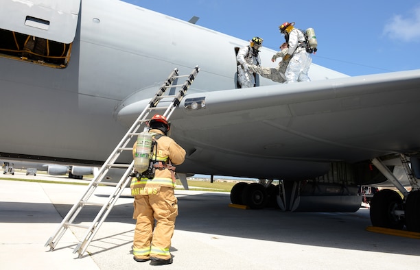 Firefighters with the 36th Civil Engineer Squadron practice egress training on a KC-135 Stratotanker on the flightline during an operational readiness exercise April 20, 2016, at Andersen Air Force Base, Guam. Egress training involves learning how to enter an aircraft to rescue any personnel on board should they become incapacitated during an emergency situation. (U.S. Air Force photo by Airman 1st Class Arielle Vasquez/Released)