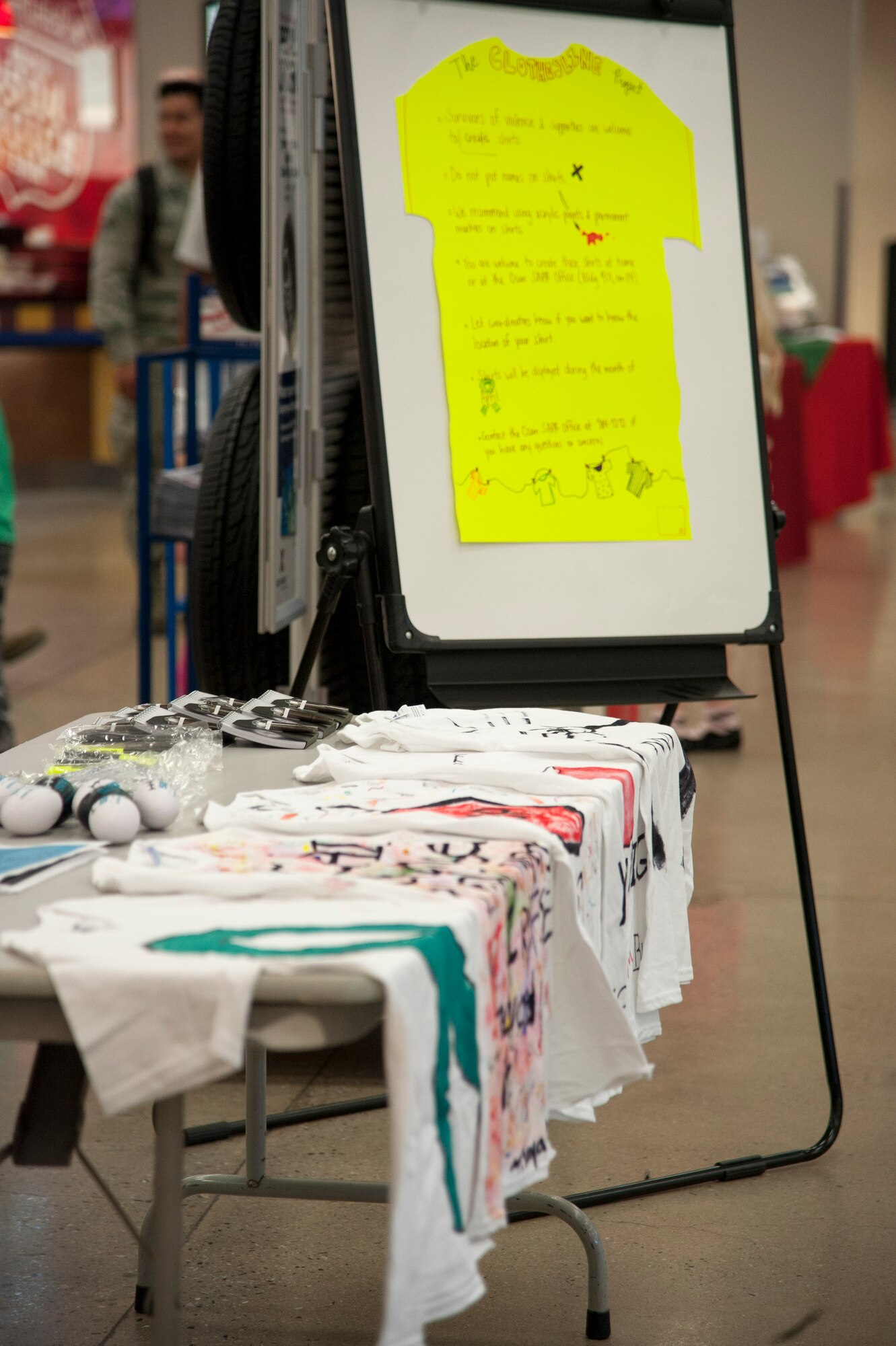 Personally designed t-shirts are displayed at the Sexual Assault Awareness Prevention Month Clothesline Project booth at the base exchange on Osan Air Base, Republic of Korea, April 12, 2016. The Clothesline Project is a national initiative intended to garner attention for men and women who have survived interpersonal violence. (U.S. Air Force photo by Jonathan Steffen/Released)