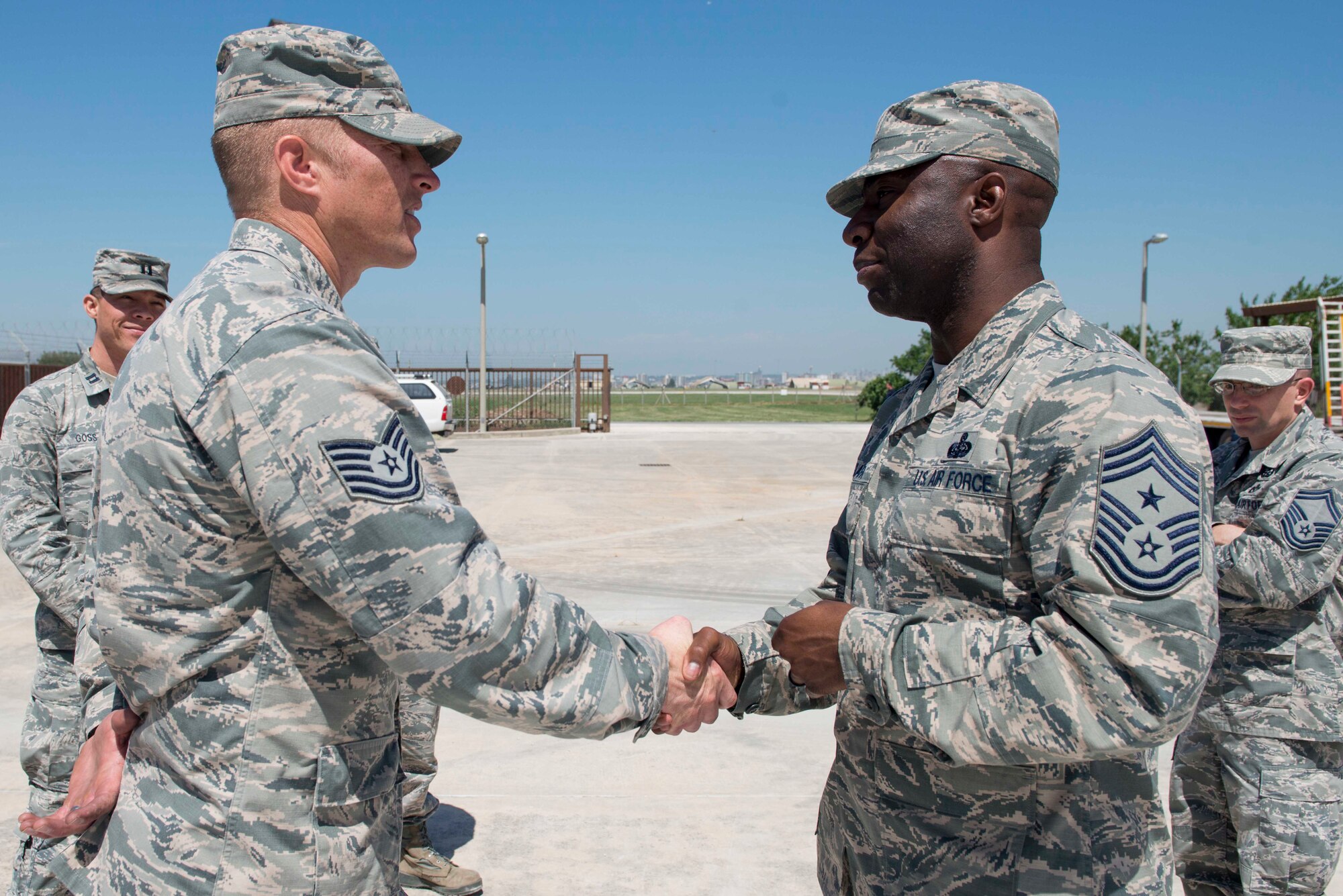 U.S. Air Force Chief Master Sgt. Vegas Clark, 39th Air Base Wing command chief, coins U.S. Air Force Tech. Sgt. Travis Hoff, 39th Civil Engineer Squadron heavy repair section chief, April 25, 2016, at Incirlik Air Base, Turkey. Clark recognized Hoff for his performance while serving as a fitness assessment cell augmentee. Hoff responded to a collapsed runner during the Air Force physical fitness test and provided first-response actions, ensuring the well-being of the member. (U.S. Air Force photo by Senior Airman John Nieves Camacho/Released)
