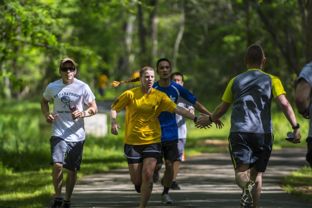 Cadets in the University of North Carolina at Charlotte ROTC program encourage each other along the route during a 5k fun run marking the 100th anniversary of the ROTC program, April 23, 2016. The ROTC program annually generates about 70 percent of the nation's Military officers. The ROTC program was officially created under the Defense Act of 1916 signed into law by President Woodrow Wilson. (U.S. Army photo Sgt. 1st Class Brian Hamilton/released)