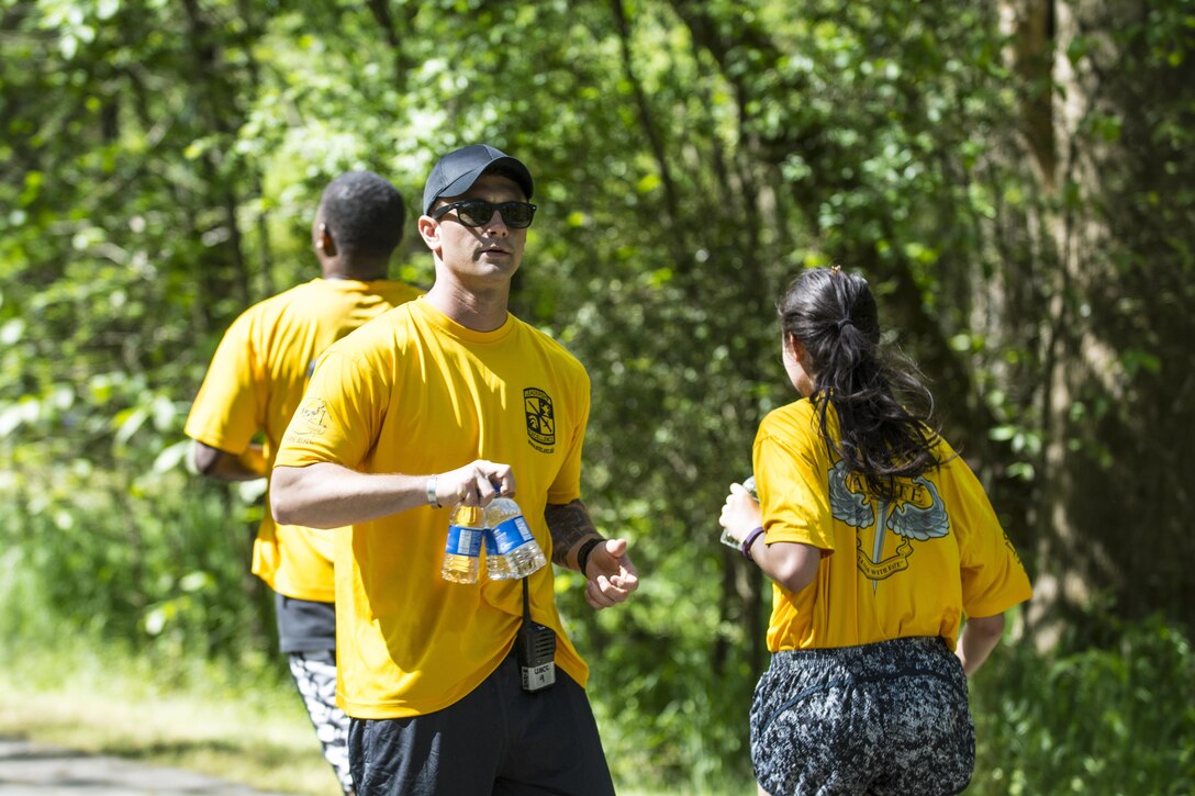 Army ROTC Cadet Joshua Dunn hands out bottles of water at the halfway point of the University of North Carolina at Charlotte ROTC 5k fun run, April 23, 2016. This year marks the 100th anniversary of the program that generates about 70 percent of the nation's Military officers. The ROTC program was officially created under the Defense Act of 1916 signed into law by President Woodrow Wilson. (U.S. Army photo Sgt. 1st Class Brian Hamilton/released)