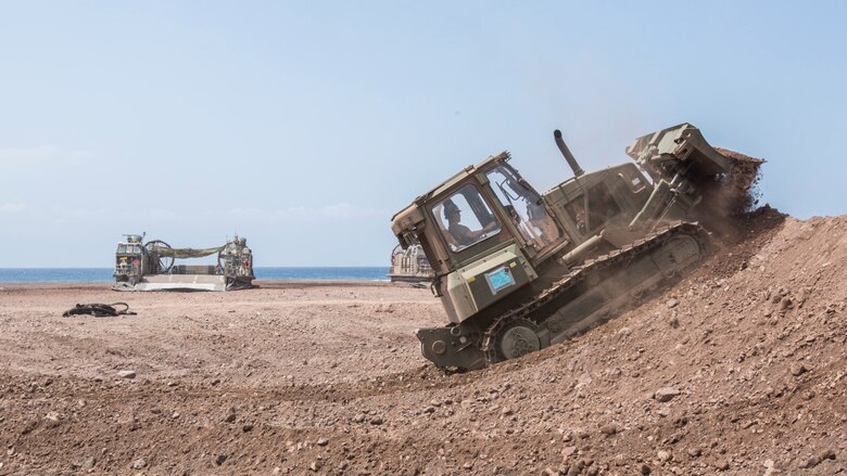 U.S. Marine Lance Cpl. Nicholas Bouvia, a heavy equipment operator with the 13th Marine Expeditionary Unit, builds a berm for security in Djibouti, Apr. 9, 2016. The 13th MEU is conducting sustainment training to maintain proficiency and combat readiness while deployed with the Boxer Amphibious Ready Group during Western Pacific Deployment 16-1. 