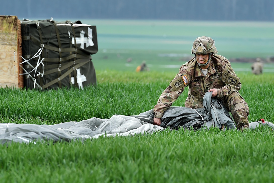 Army Lt. Col. Benjamin Bennett collects his parachute during airborne operations as part of exercise Saber Junction 16 near Hohenfels, Germany, April 12, 2016. Bennett is commander of 54th Brigade Engineer Battalion, 173rd Airborne Brigade. Army photo by Gertrud Zach