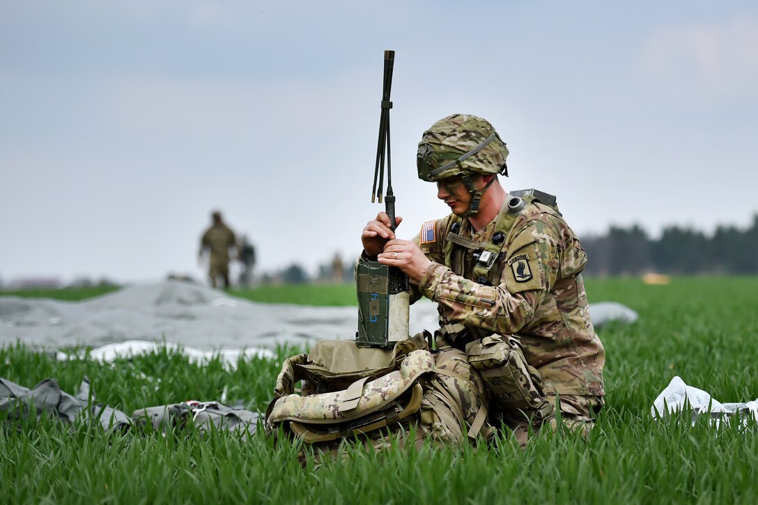 An Army paratrooper assembles his radio equipment during airborne operations as part of exercise Saber Junction 16 near Hohenfels, Germany, April 12, 2016. Army photo by Gertrud Zach