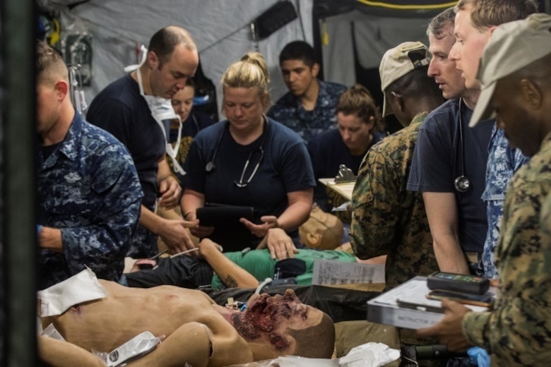 Sailors with 2nd Medical Battalion address simulated trauma victims during the final scenario of Health Service Augmentation Program training at Camp Lejeune, N.C., April 22, 2016. HSAP training, a week-long field exercise, is geared towards training medical personnel to function in a shock trauma platoon in a deployed environment.