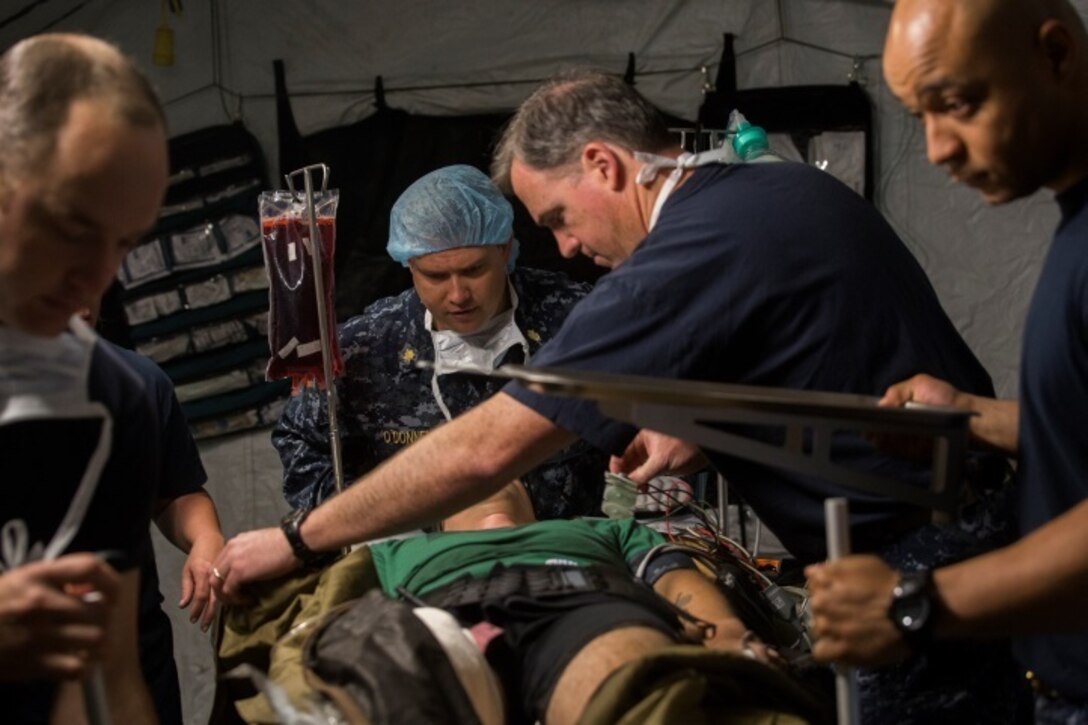 Sailors with 2nd Medical Battalion prepare a simulated trauma victim for surgery during Health Service Augmentation Program training at Camp Lejeune, N.C., April 22, 2016. Sailors attached to the Camp Lejeune Naval Hospital underwent a week-long training exercise that familiarized them with the gear and operations of a shock trauma platoon in a deployed environment