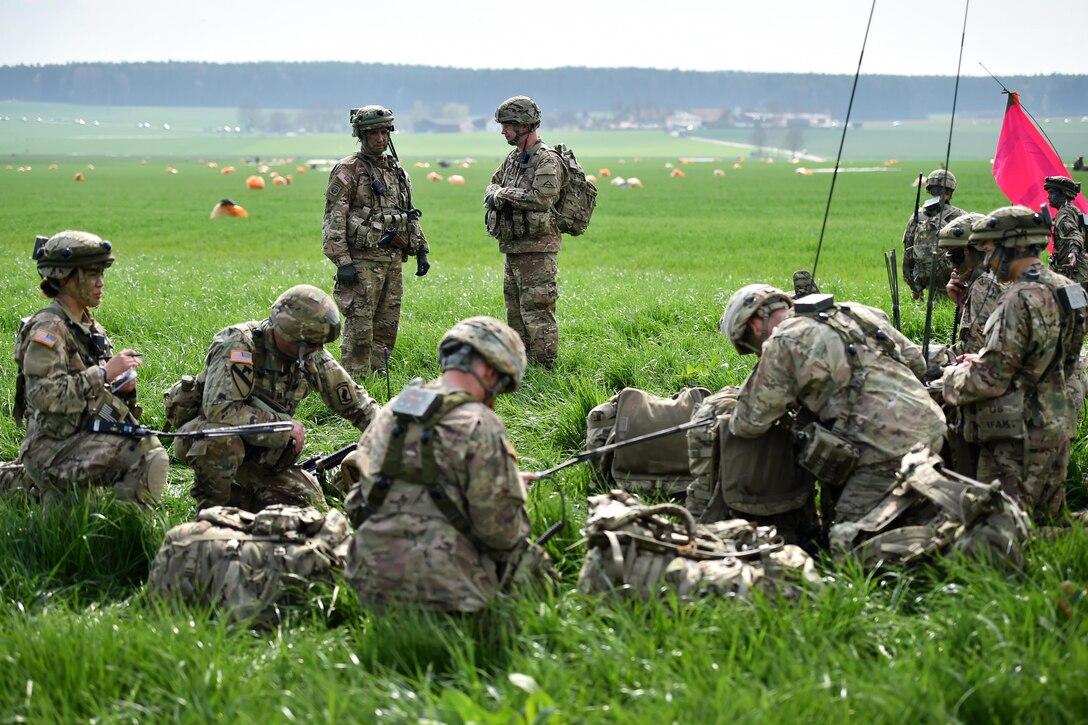 Army Col. Gregory Anderson, standing right, and Lt. Col. Benjamin Bennett converse during an airborne operation as part of exercise Saber Junction 16 near Hohenfels, Germany, April 12, 2016. Anderson is commander of the 173rd Airborne Brigade and Bennett is commander of the brigade’s 54th Engineer Battalion. Army photo by Gertrud Zach