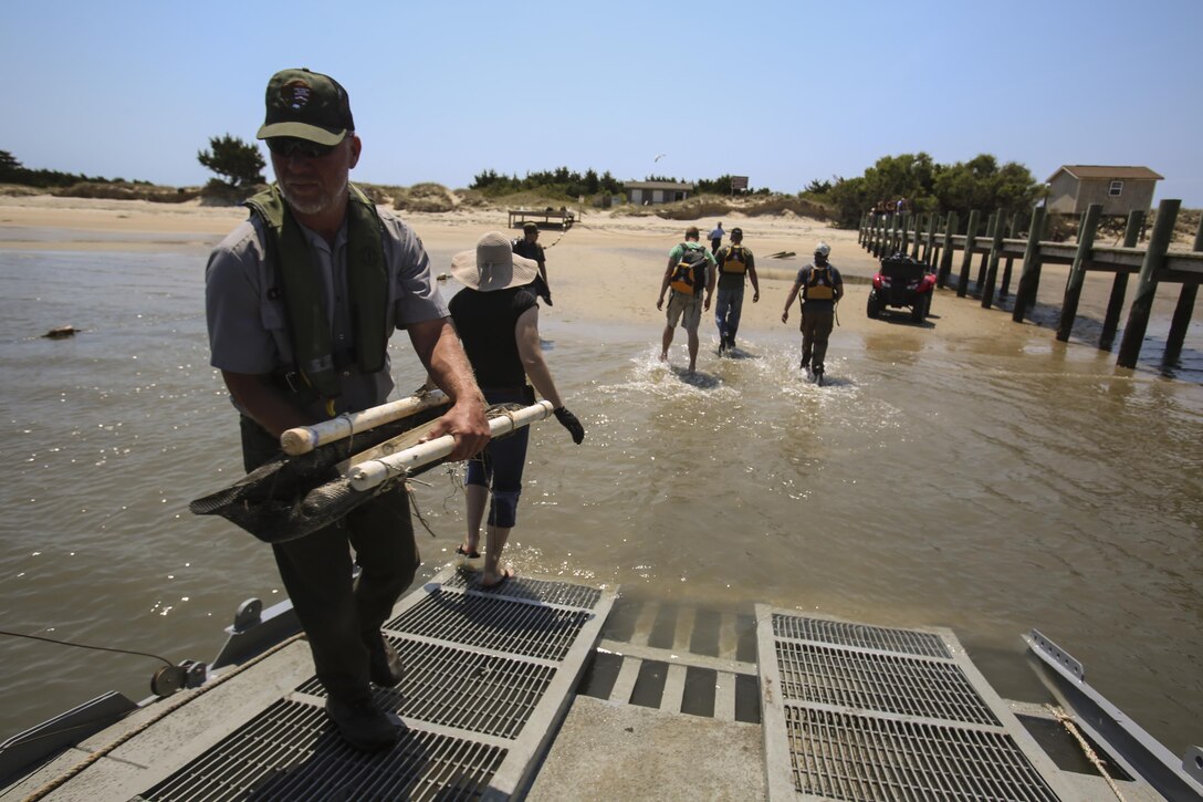 Marines from 2nd Radio Battalion and 2nd Law Enforcement Battalion worked in cooperation with the National Park service to clean up debris from Shackleford Banks Island on April 21, 2016. The pollution comes to the island from the ocean due to hurricanes and littering; the goal is to clean the island biannually to reduce the risk of it affecting the wildlife and the wild horses inhabiting the island. (U.S. Marine Corps photo by Lance Cpl. Miranda Faughn/Released)