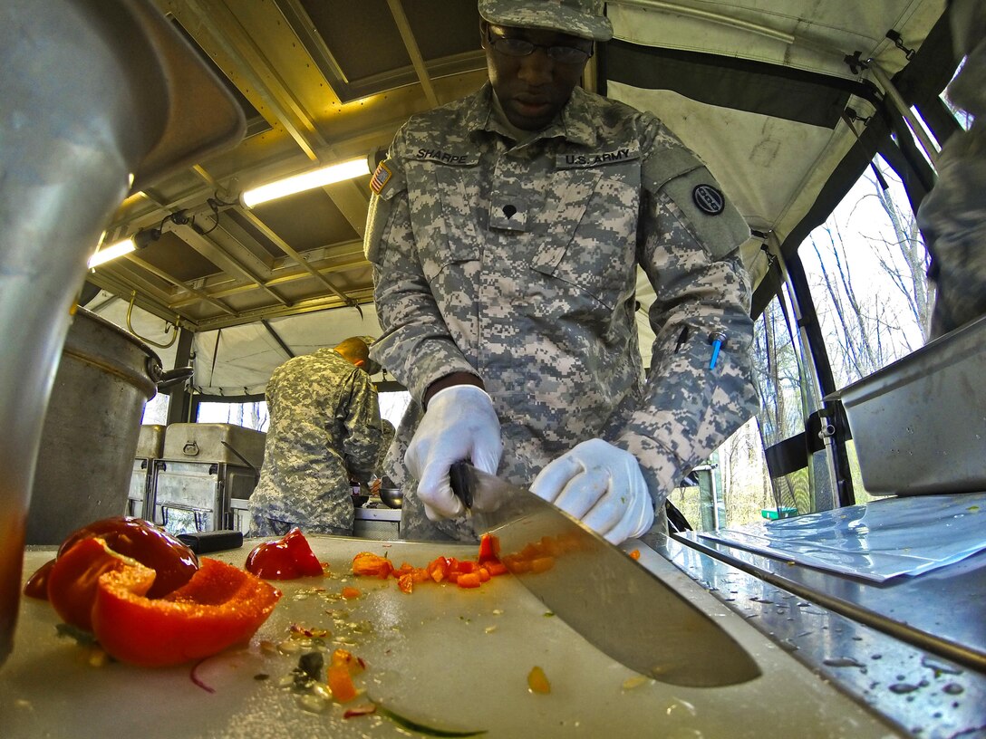 Spc. Jordan Sharpe, a food service specialist with the 733rd Transportation Company, slices a red pepper during the annual Philip A. Connelly Award competition at Fort Indiantown Gap, Pa., April 23, 2016. (U.S. Army photo by Staff Sgt. Dalton Smith / Released)