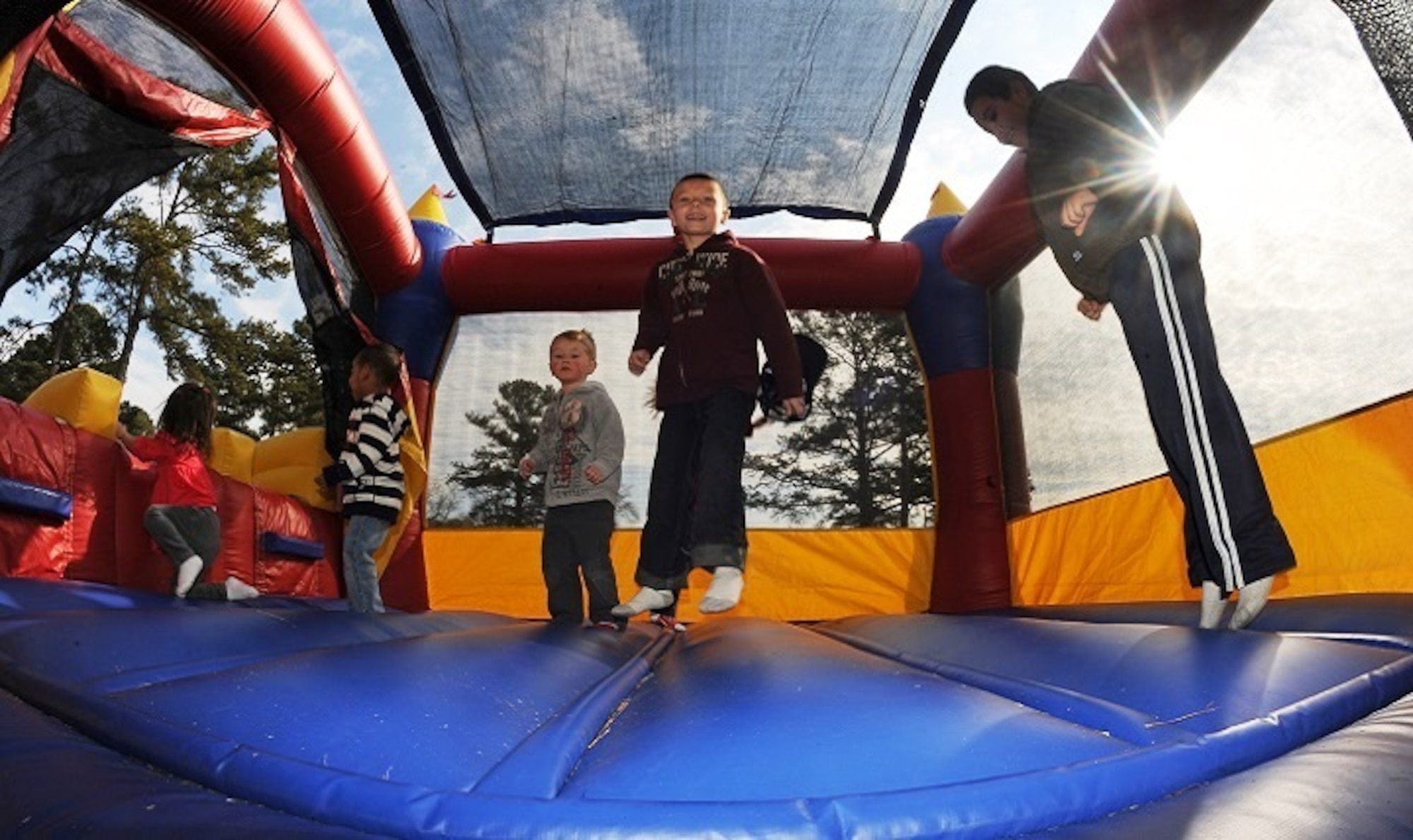 A group of children play inside of a bounce house during the Easter egg hunt event at Debden Park on Seymour Johnson Air Force Base, N.C., March 30, 2013. The bounce house was a side activity those who came out to the hunt could play in. (U.S. Air Force photo/Airman 1st Class John Nieves Camacho/Released)