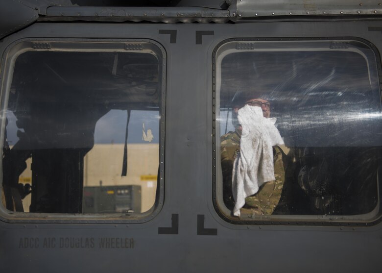 Staff Sgt. Matthew Thompson, 455th Expeditionary Aircraft Maintenance Squadron electronic countermeasures journeyman, cleans the windorws during a pre-flight inspection for a HH-60G Pave Hawk before takeoff at Bagram Airfield, Afghanistan, April 25, 2016. The HH-60G is the main aircraft used for Air Force search and rescue teams but also carries out civil search and rescue, medical evactuation, disaster response, and humanitarian assistance. (U.S. Air Force photo by Senior Airman Justyn M. Freeman)