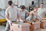 Airman 1st Class James Witter, Airman 1st Class Katie Welsh, Senior Airman Matti Schake, and Tech. Sgt. Rusty Zortman, members of the 155th Sustainment Services Flight, prepare Unit Group Rations to serve lunch to the 155th Small Air Terminal, who traveled to the Transportation Proficiency Center at Dobbins ARB, Ga., July 11-14, 2014. Services sent three Airmen in upgrade training to learn how to serve a large group away from home station.