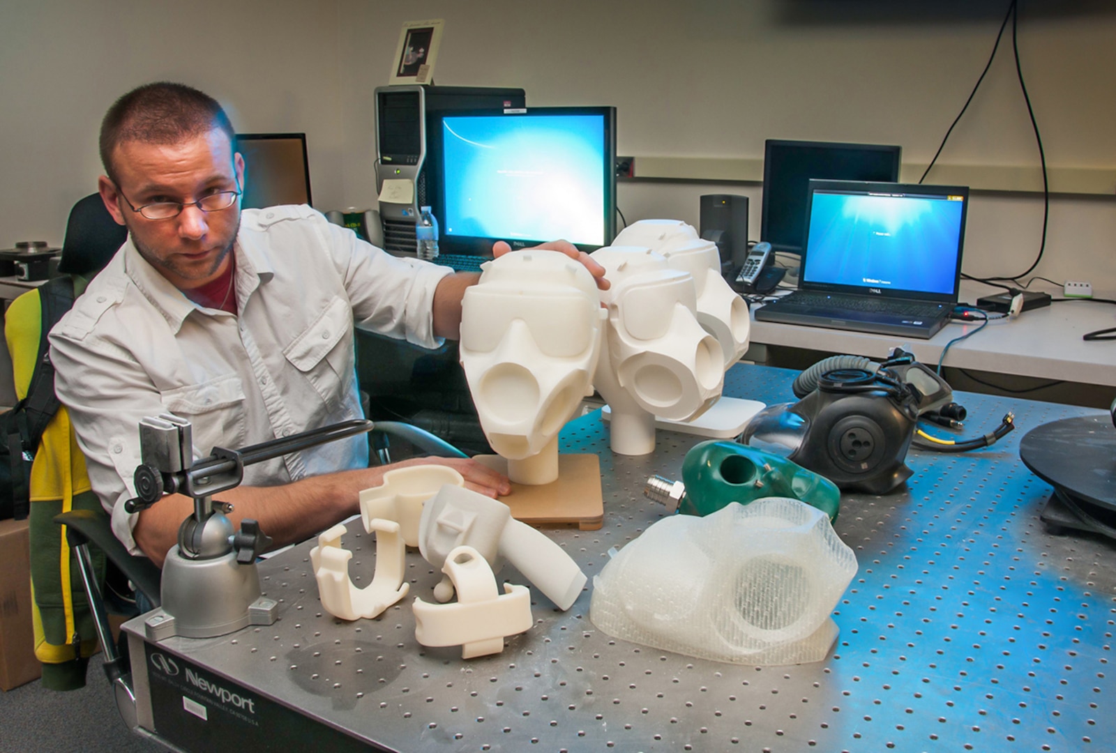 3-D modeling artist Ryan Gilley displays some of the products he designed and printed using advanced manufacturing techniques at the Edgewood Chemical Biological Center, Aberdeen Proving Ground, Md.