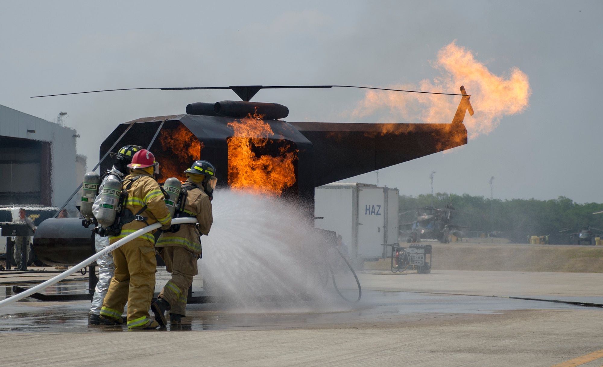 Firefighters participate in live-fire training during a weeklong exercise at Soto Cano Air Base, Honduras, April 20, 2016. Joint Task Force-Bravo hosted firefighters from Belize, Guatemala, El Salvador, Honduras, Nicaragua, Costa Rica, and Panama for the Central America Sharing Mutual Operational Knowledge and Experience exercise April 18-22. (U.S. Air Force photo/Capt. David Liapis)
