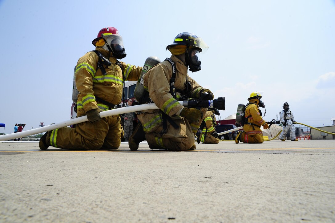 Firefighters from some of the seven Central American nations participate in live-fire training during a weeklong exercise at Soto Cano Air Base, Honduras, April 20, 2016. Joint Task Force-Bravo hosted firefighters from Belize, Guatemala, El Salvador, Honduras, Nicaragua, Costa Rica, and Panama for the Central America Sharing Mutual Operational Knowledge and Experience exercise April 18-22. (U.S. Army photo/Martin Chahin)