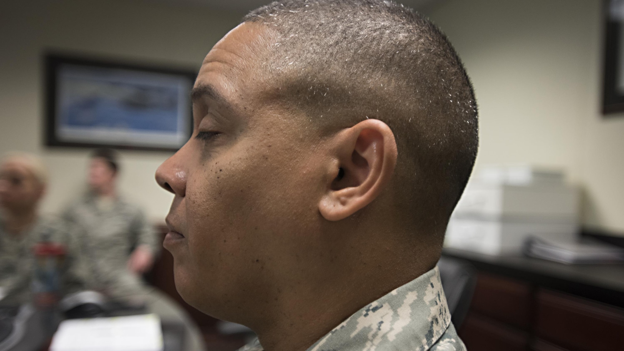 A member of the 305th Operations Support Squadron leadership team participates in a “mindful minute” meditation session during a staff meeting April 20, 2016, at Joint Base McGuire-Dix-Lakehurst, N.J. The mindful minute is part of an ongoing mindful initiative to improve the mental fitness of Airmen. (U.S. Air Force photo/Staff Sgt. Katherine Tereyama)