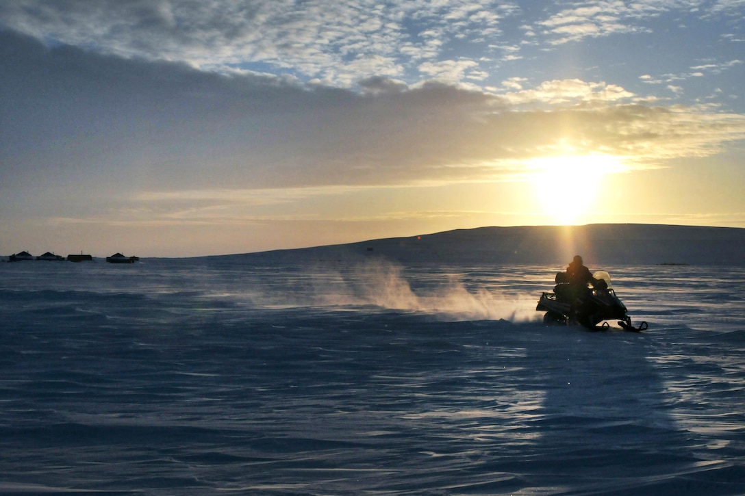 An airman operates a snowmobile after preparing a ski-way for aircraft at Little Cornwallis Island, Nunavut, Canada, April 10, 2016, in support of Canada's annual Operation Nunalivut. Air National Guard photo by Airman 1st Class Jamie Spaulding