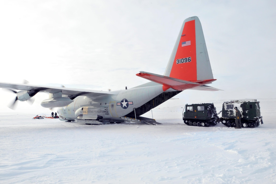 An Air Force loadmaster loads a Canadian transport vehicle onto an LC-130 Hercules aircraft at Little Cornwallis Island, Nunavut, Canada, April 13, 2016, in support of Canada's annual Operation Nunalivut. Air National Guard photo by Airman 1st Class Jamie Spaulding