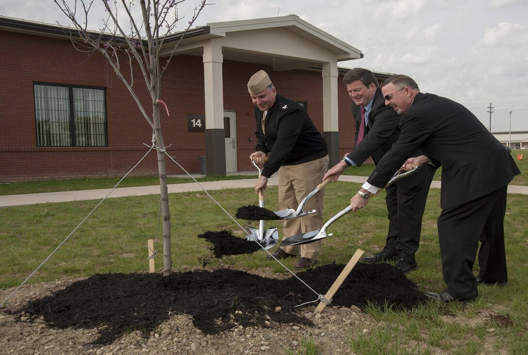 Defense Supply Center Columbus leaders help plant one of 14 saplings at the Stephen F. Byus Community Center April 25 as part of the installation's Earth Day activities. From left, Defense Logistics Agency Land and Maritime Chief of Staff Navy Capt. Justin Debord, Installation Site Director Dan Bell, and DLA Land and Maritime Deputy Chief of Staff Griff Warren.